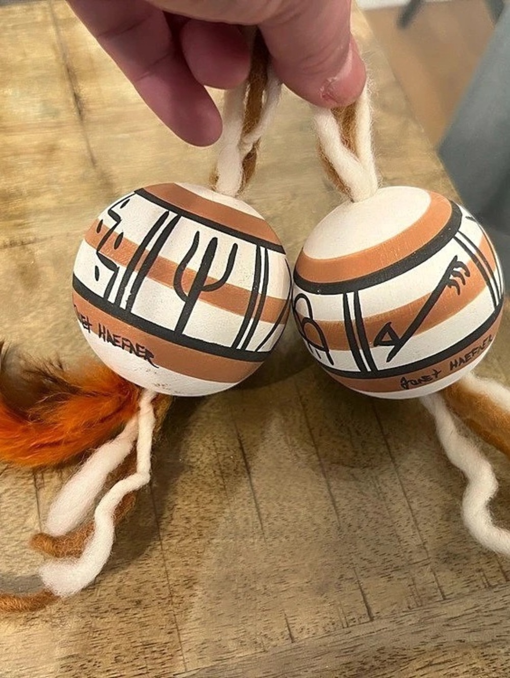 Signed pair of Southwestern Native American-style painted gourd or clay ornament